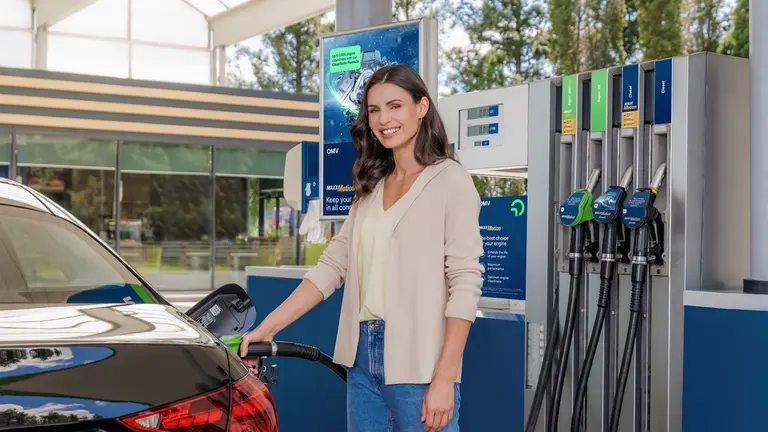 A woman fueling up on an OMV filling station