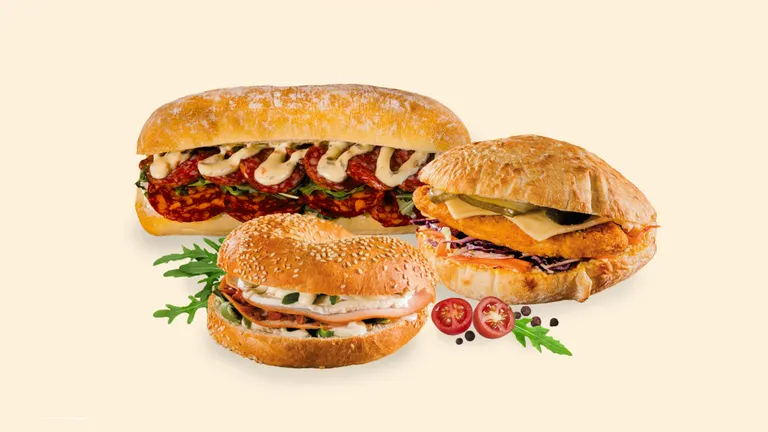 Three sandwiches on a beige background