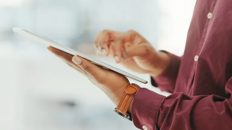 A person holding a tablet.